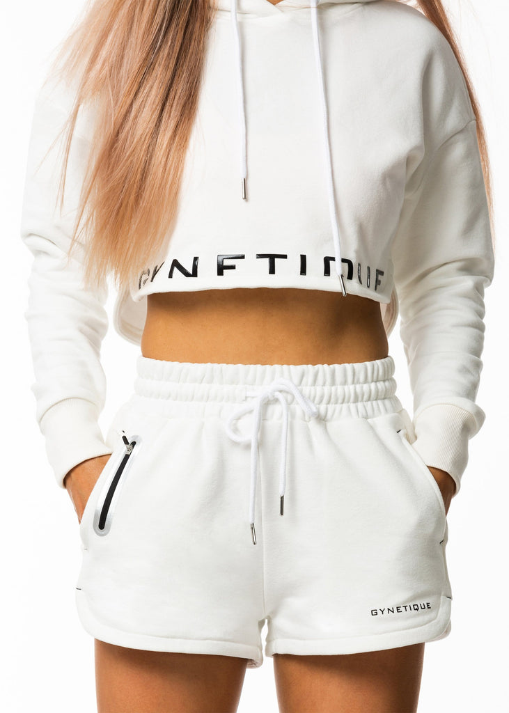 Women's casual clothing nz, white cropped hoodie with drawstring, Sie split hem, black gynetique logo, long sleeve