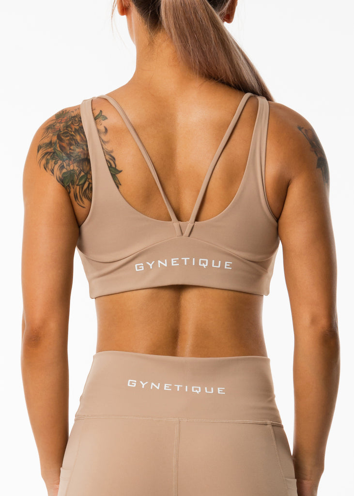 Women's sportswear online, Gynetique Intense collection beige padded sports bra, logo on back, two straps, round scoop neck, elastic waist band