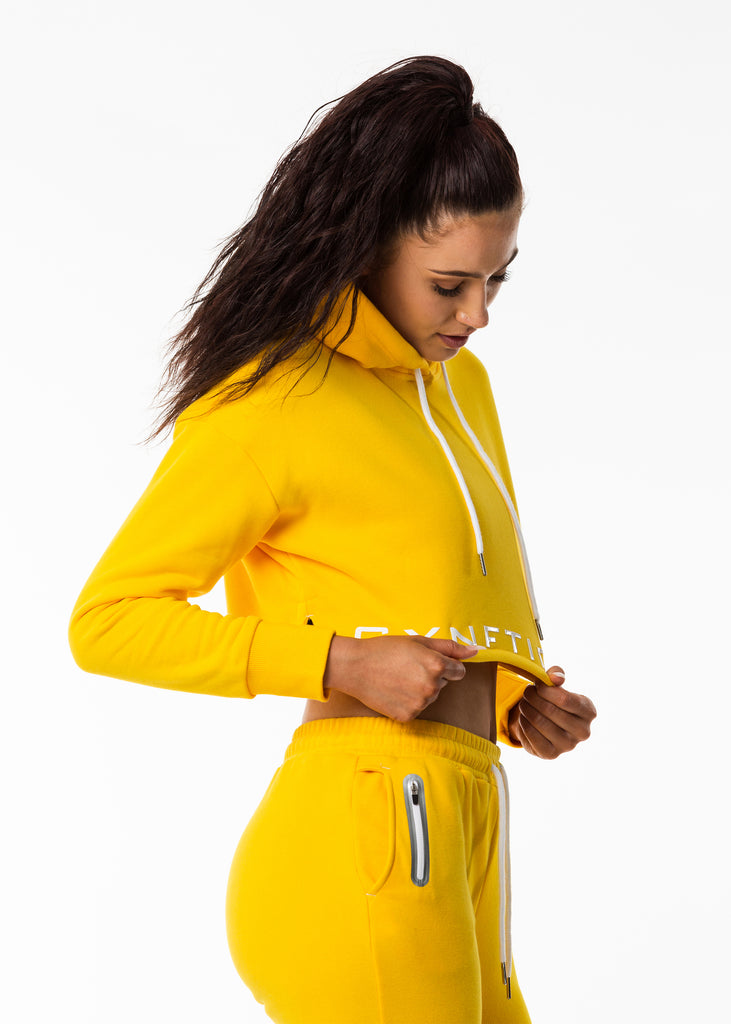 Women's sportswear New Zealand, bright sunflower yellow crop length hoodie, gynetique logo front, white drawstring, split side hem