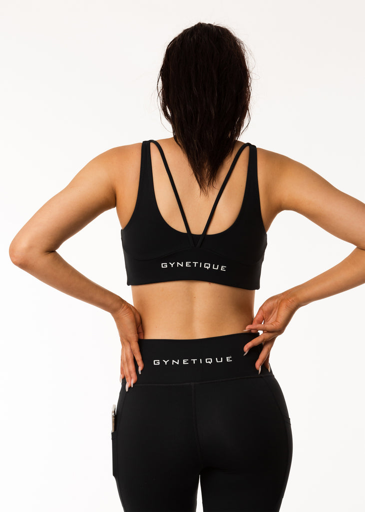 Women's gym wear brand nz, Gynetique Intense collection black sports bra, padded cups, two back straps, logo on back, elastic waist band