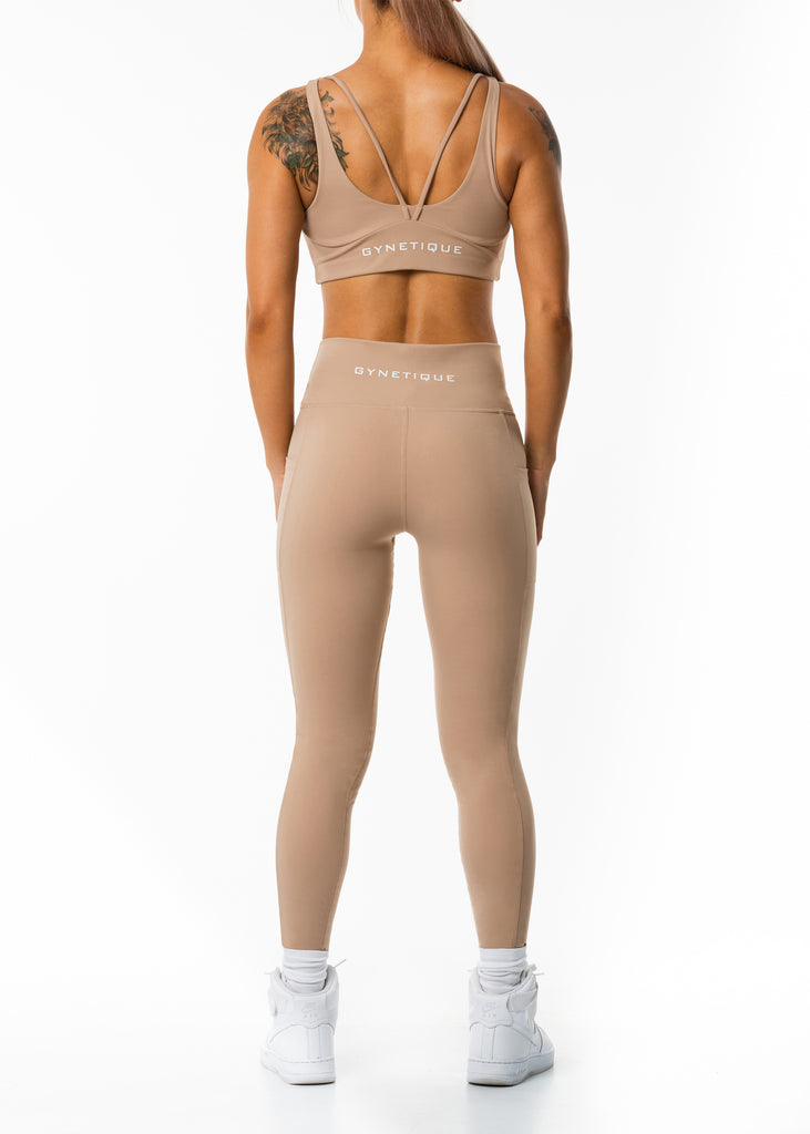 Women's workout clothes online, Gynetique Intense collection beige sunset blush sports bra, removable padded cups, wide should straps, elastic waist band, round scoop neck, white logo on back